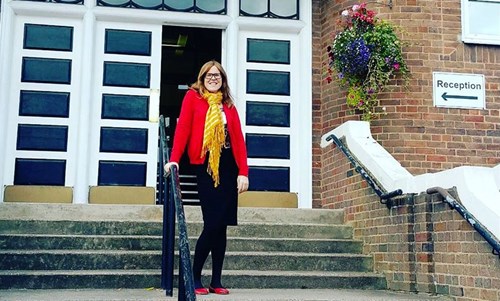 Megan Key standing outside her old school